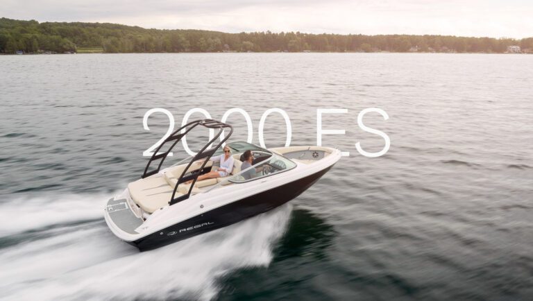 Couple cruising in a Regal 2000 ES sterndrive bowrider at high speed on a calm lake.