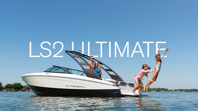 Regal LS2 bowrider gliding on a calm lake with passengers enjoying a sunny afternoon