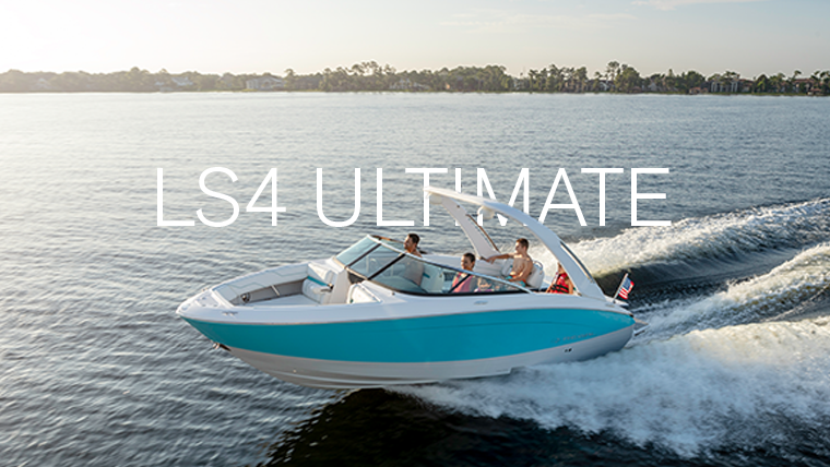 Regal LS4 bowrider anchored on open water with two passengers relaxing at the bow